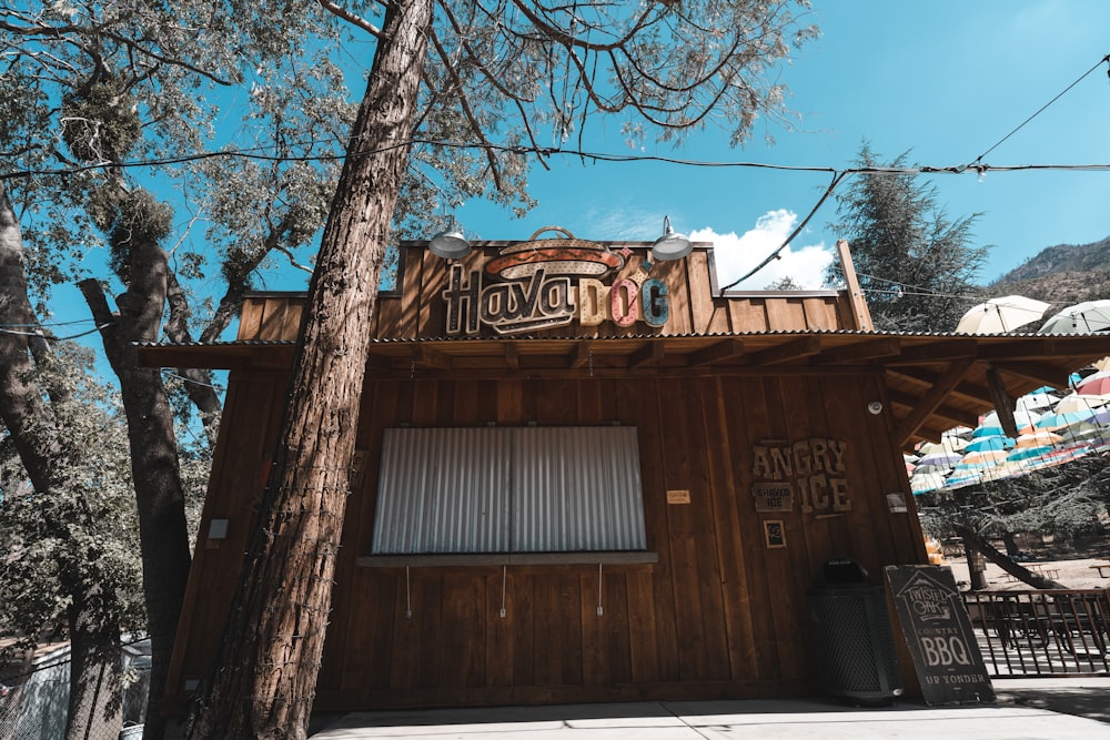 a wood building with a sign on it