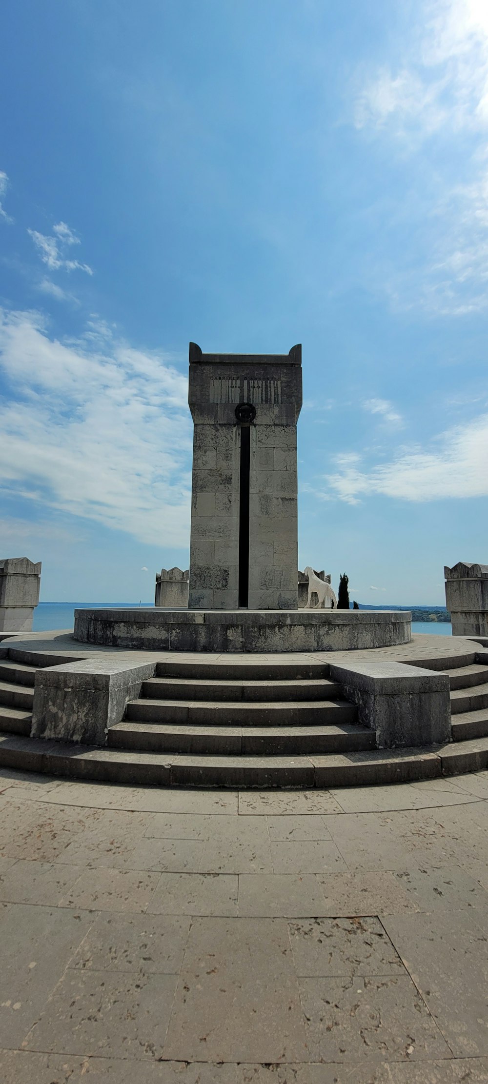 a stone monument with a person standing on it