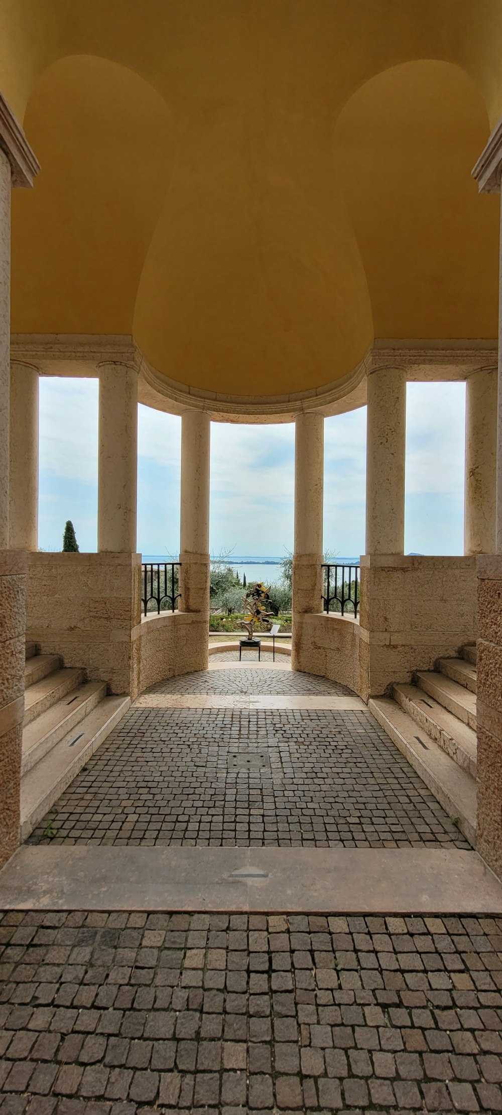 a stone walkway with pillars