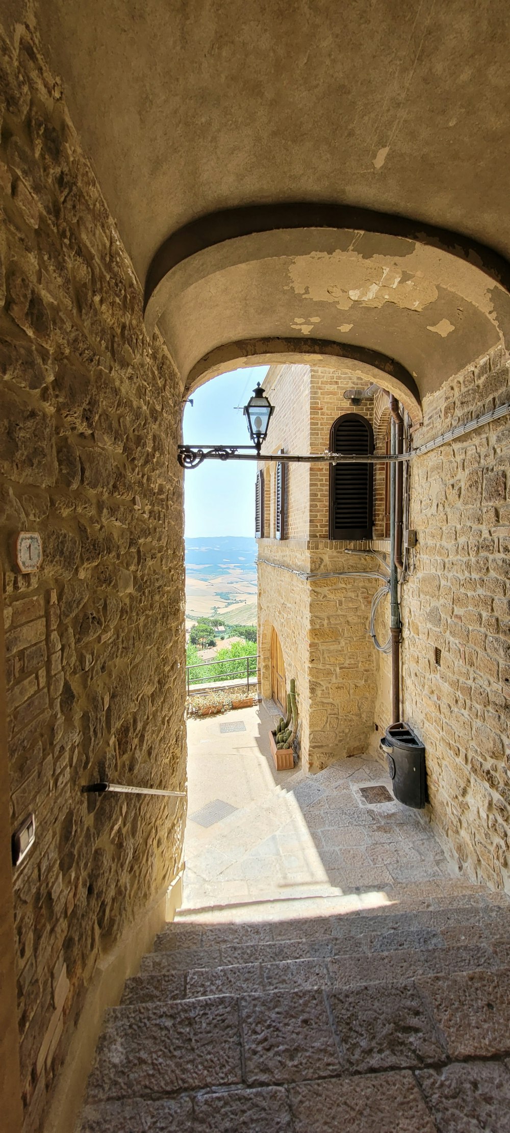 a stone walkway with a stone archway