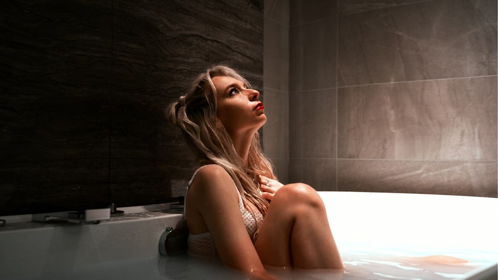 a woman sitting in a bathtub