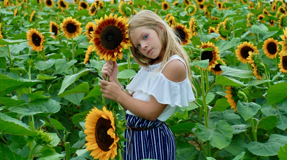 a girl posing in a field of sunflowers
