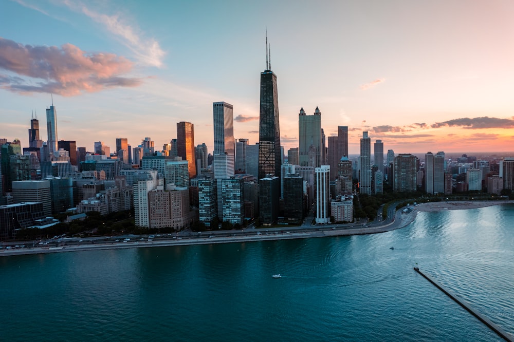 a city skyline with a body of water in front of it