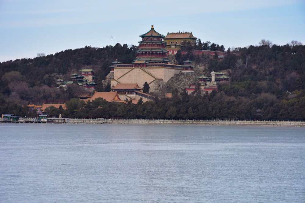 a building on a hill by the water