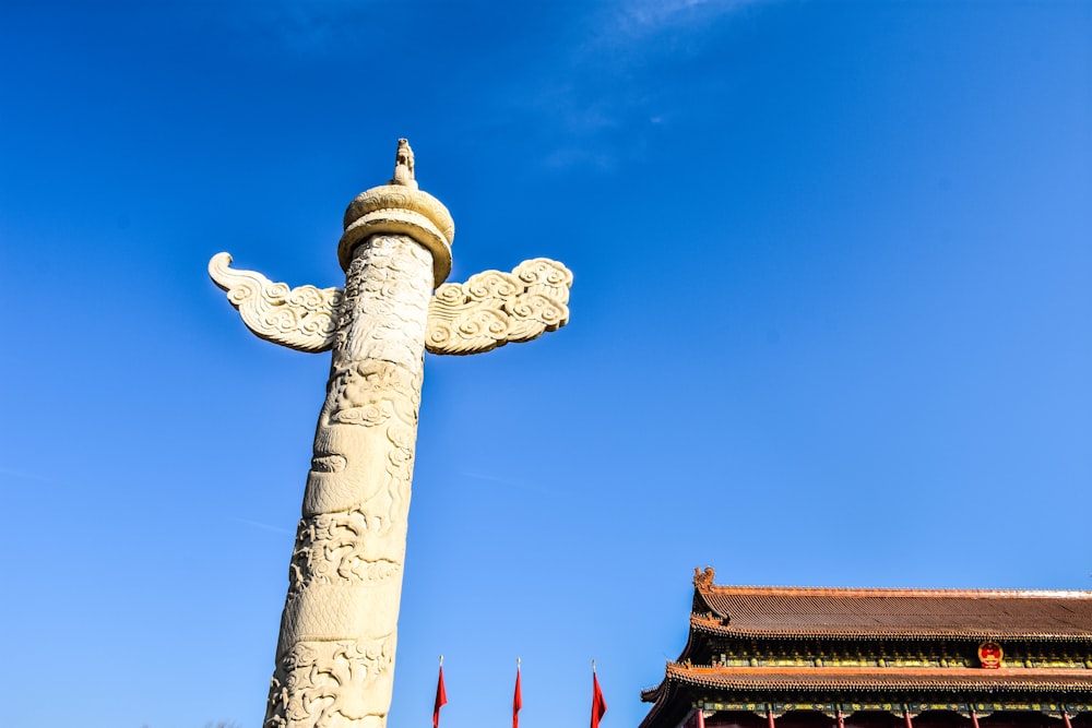 a statue of a person holding a cross