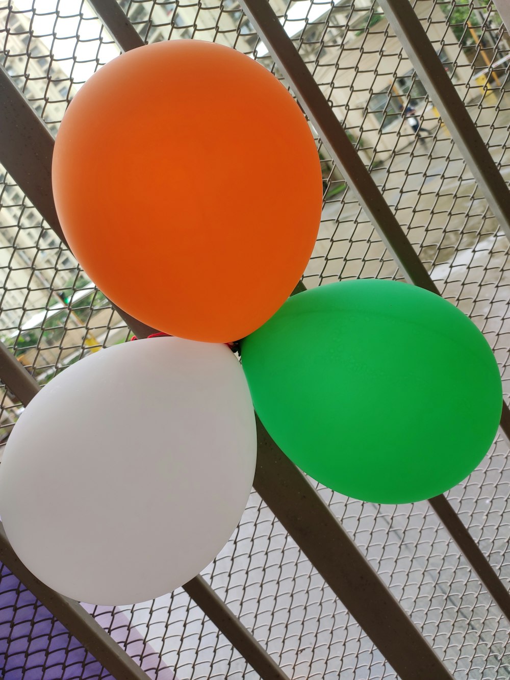 a group of balloons in a cage