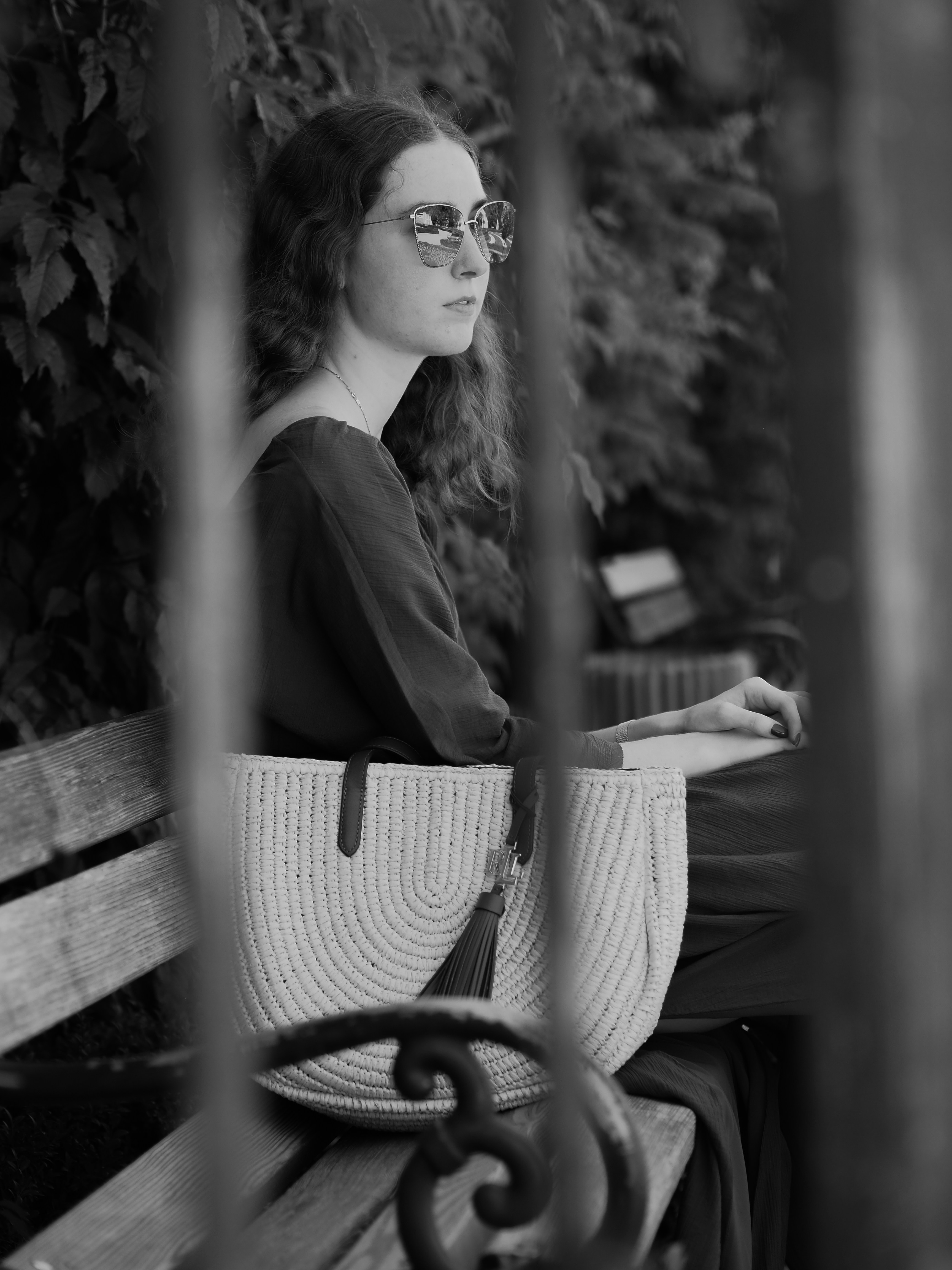 Woman looking out a window with a thoughtful, slightly melancholic expression, representing feelings of emptiness and contemplation during her cycle.