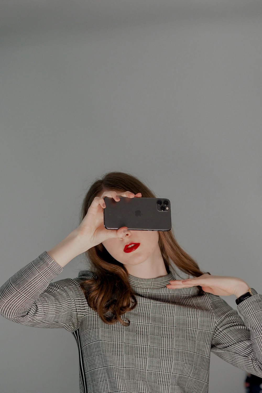 a woman holding a phone to her face