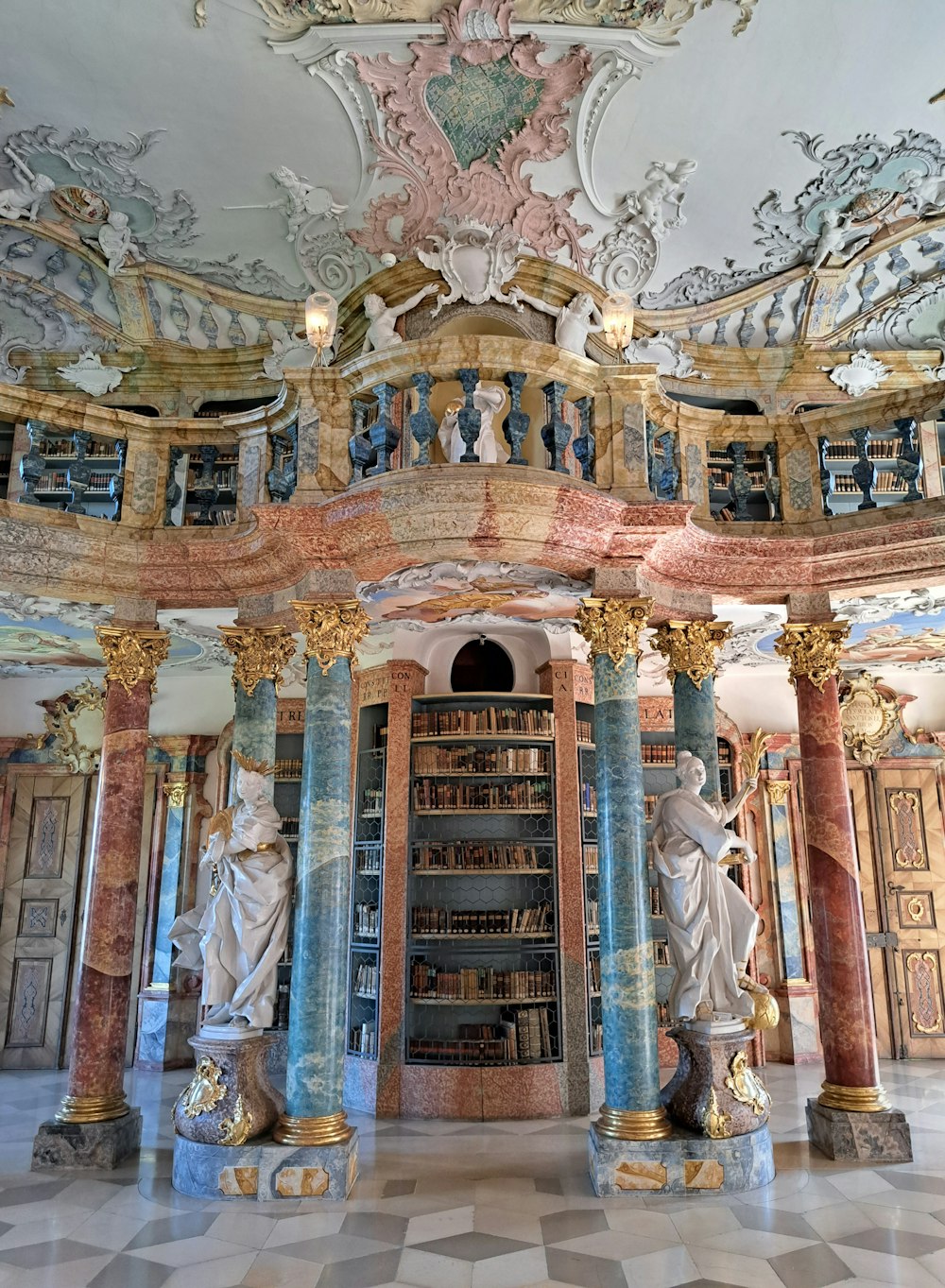 a room with statues and books