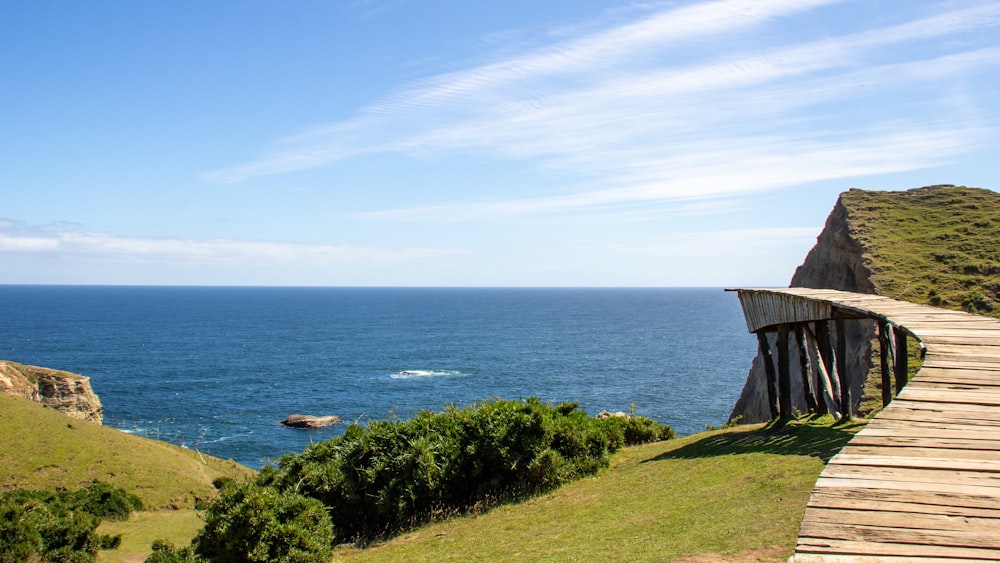 a wooden walkway to a body of water