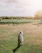 A joyful couple exchanging vows in a sunlit vineyard surrounded by blooming grapevines.