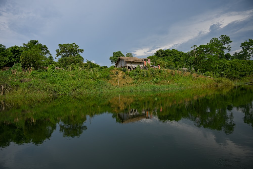 a house on a hill by a lake