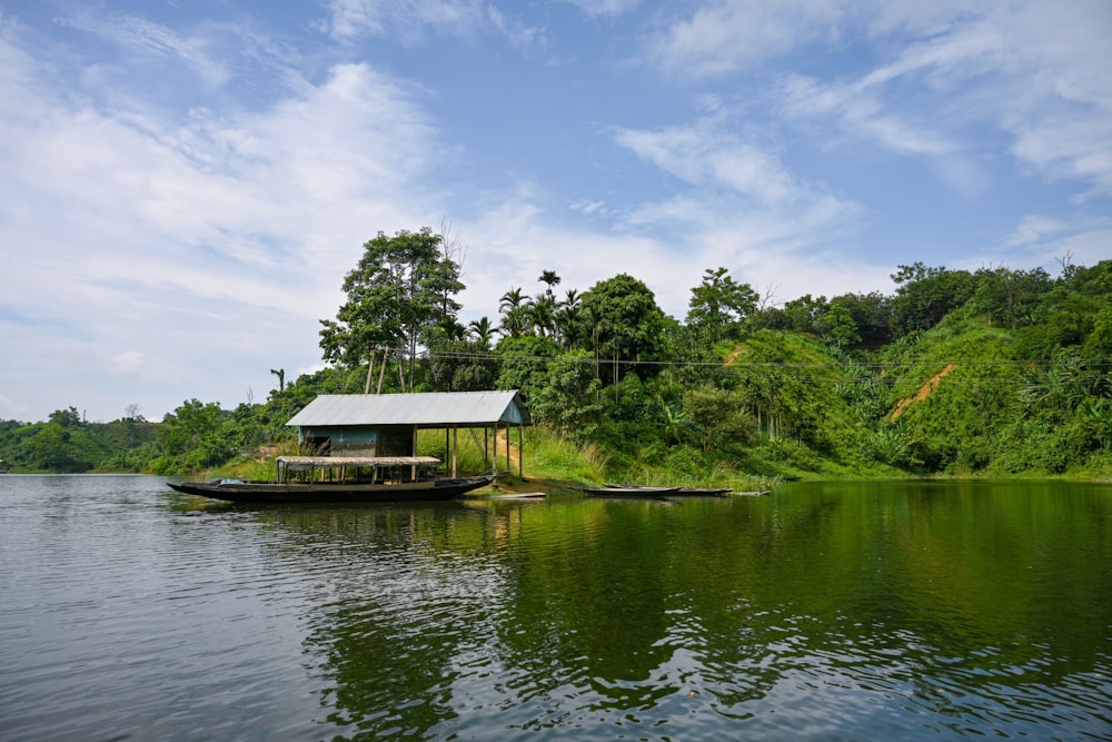 a small house on a dock in a lake