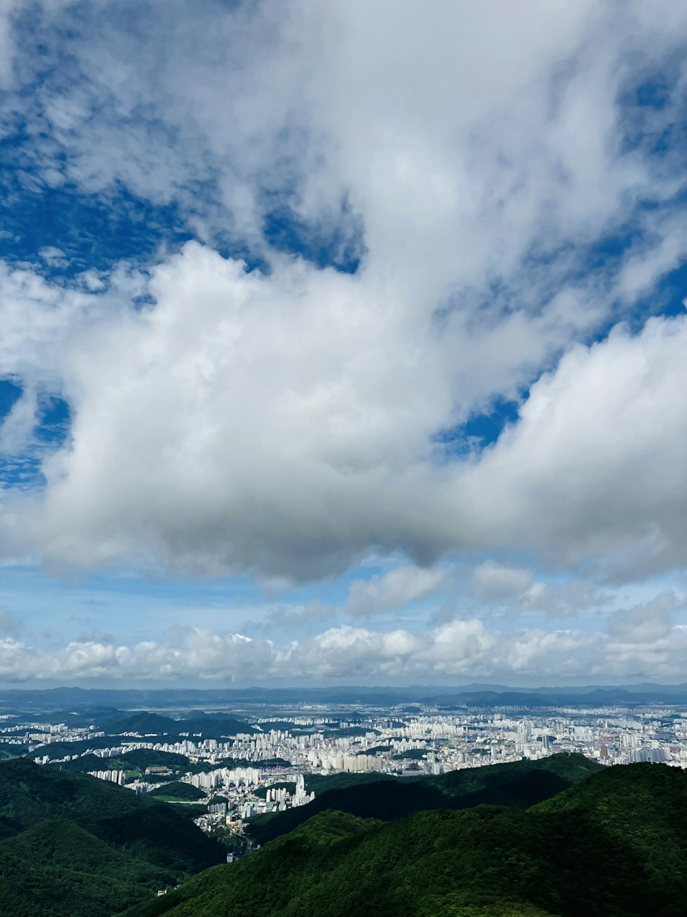 a landscape with a body of water and a city in the distance