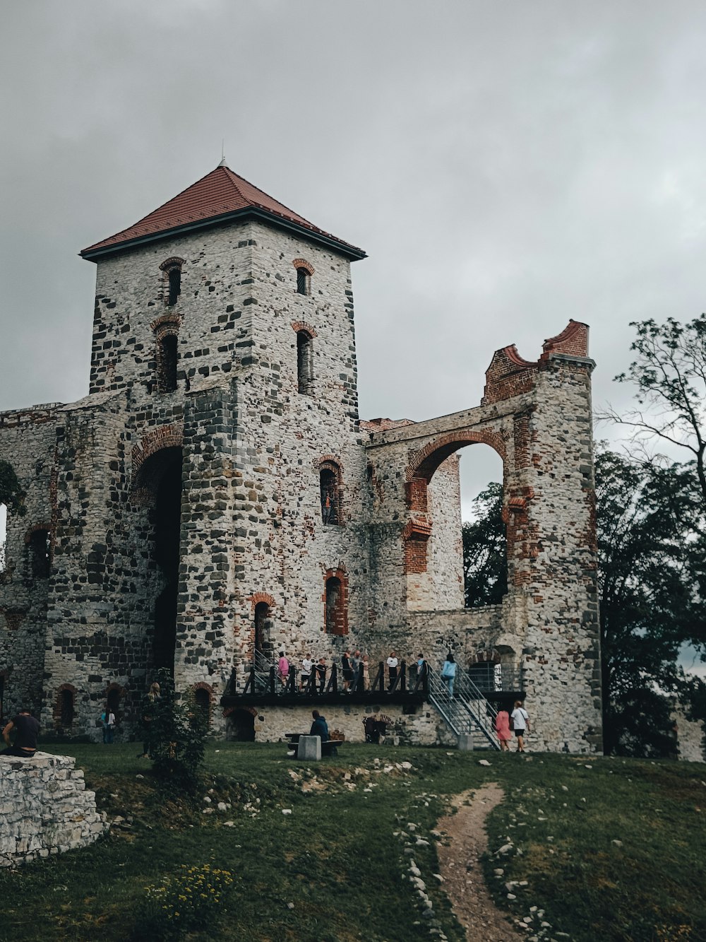 a stone building with a group of people walking up stairs