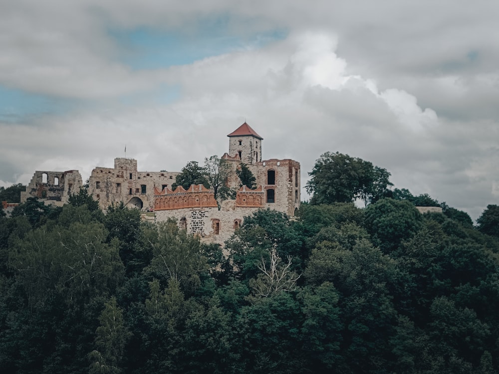 a large building on top of a hill with trees below