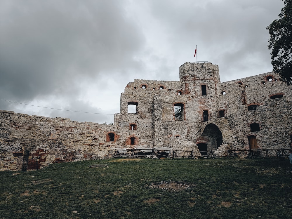 a stone castle with a flag on top