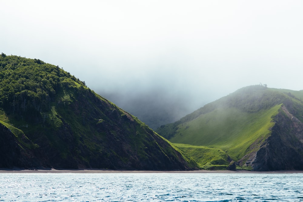 a body of water with hills in the back