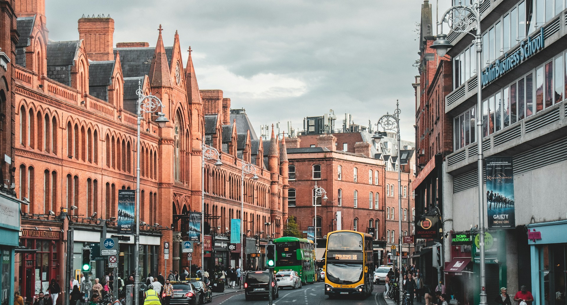 a city street with buses and cars