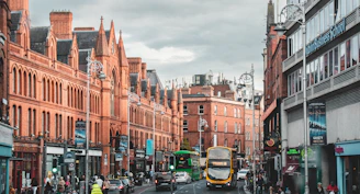 a city street with buses and cars