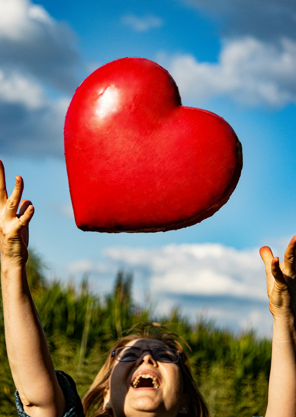 a person holding a red balloon