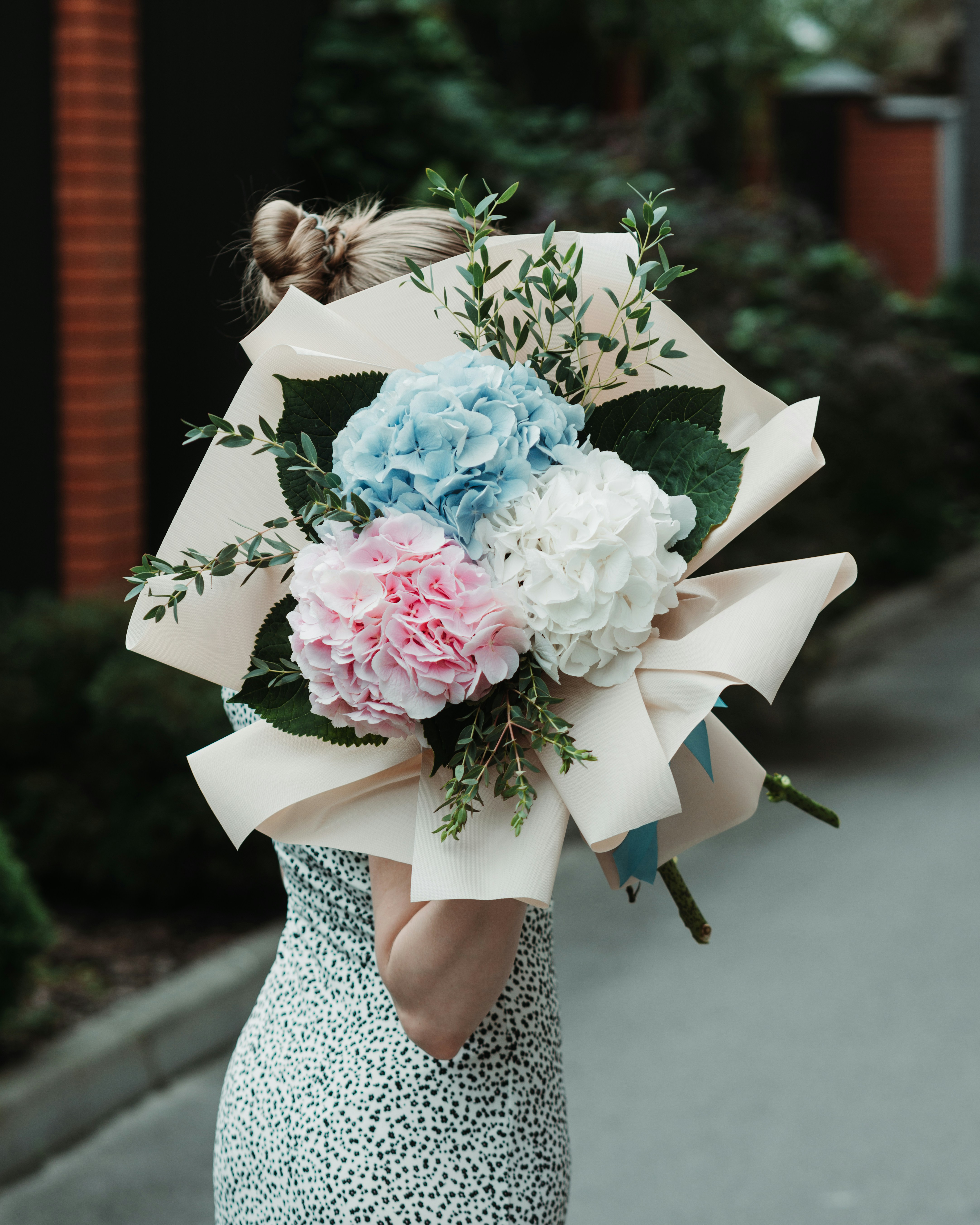 a woman wearing a white dress with flowers on it