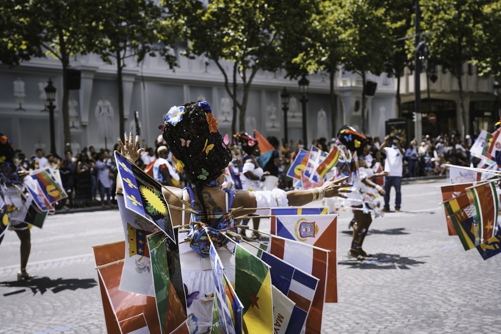 a group of people in clothing holding flags