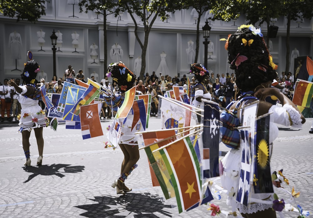 a group of people in clothing holding flags