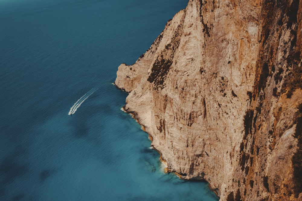 a cliff with a body of water below