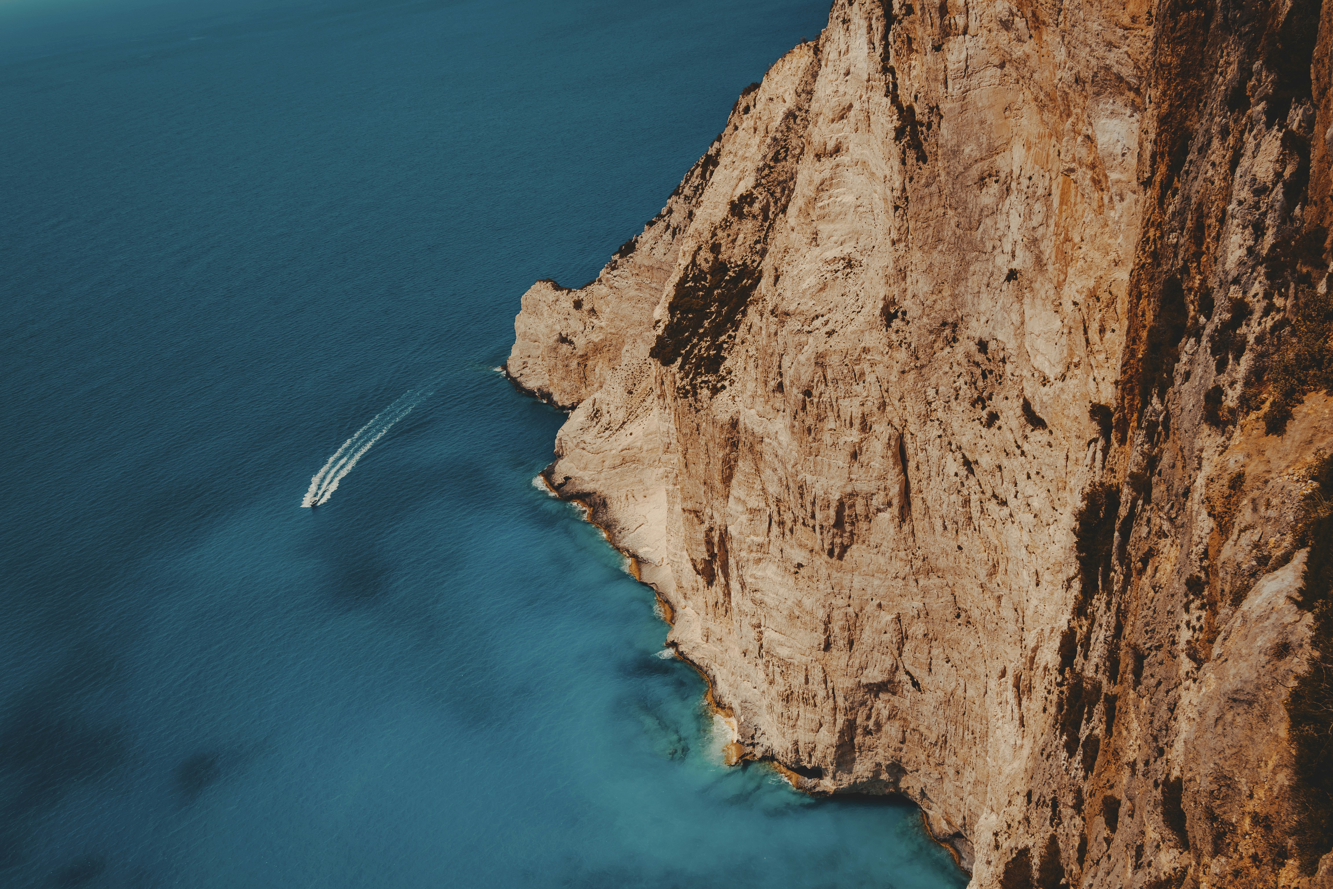 a cliff with a body of water below