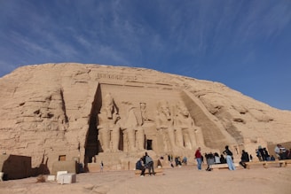 Tour guide Nicolai smiling next to the famous Piedra del Peñol with tourists admiring the view.