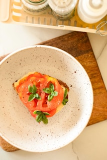 A chef slicing mozzarella cheese with fresh basil and olive oil.