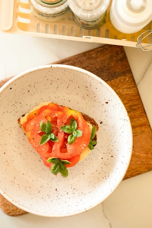 A chef slicing mozzarella cheese with fresh basil and olive oil.