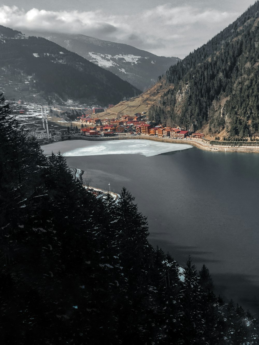 a body of water with mountains around it