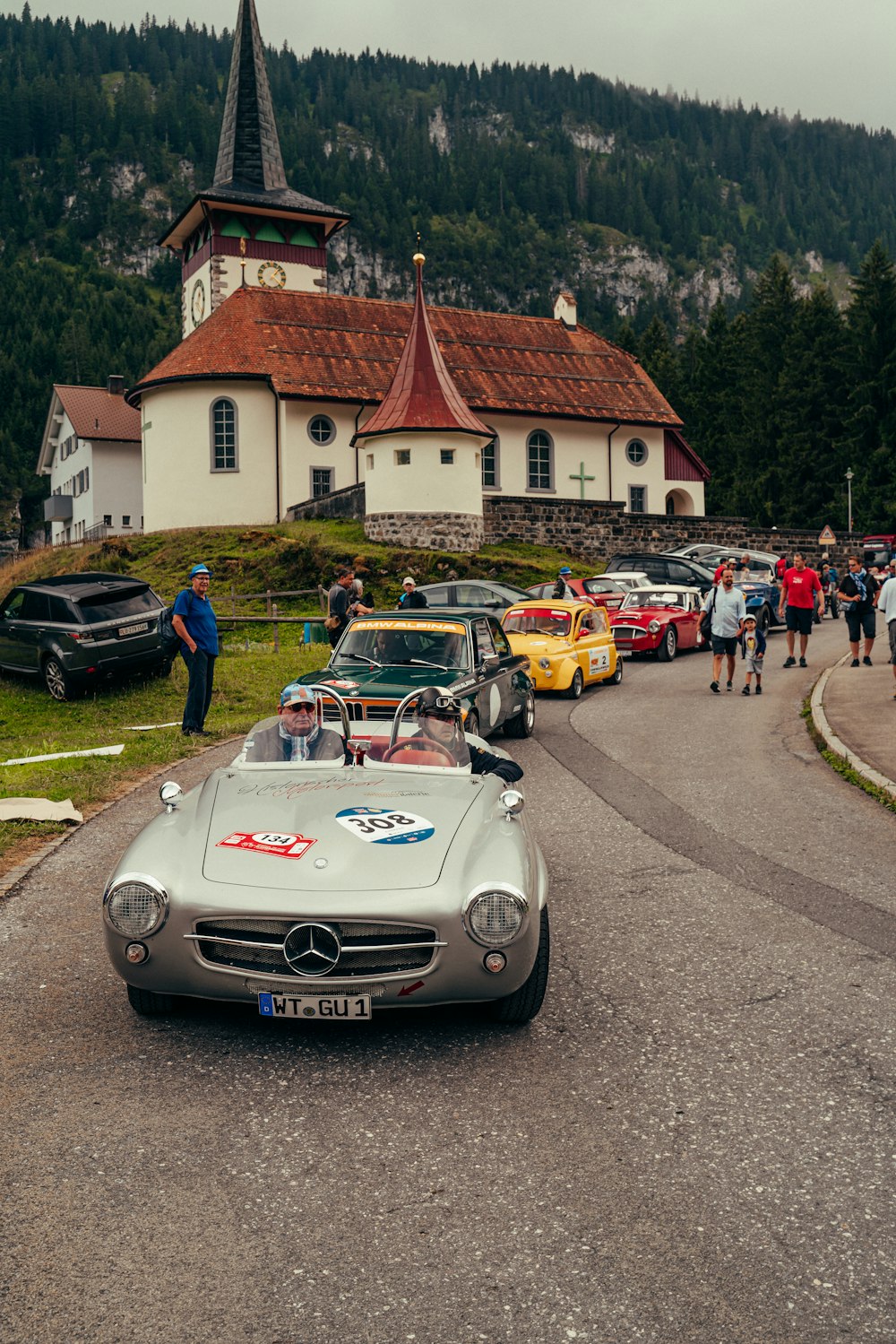 a group of cars parked in front of a church