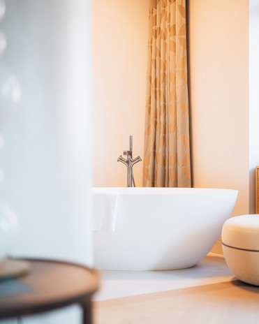A skilled installer fitting a sleek bathtub in a bright, modern Louisville bathroom.