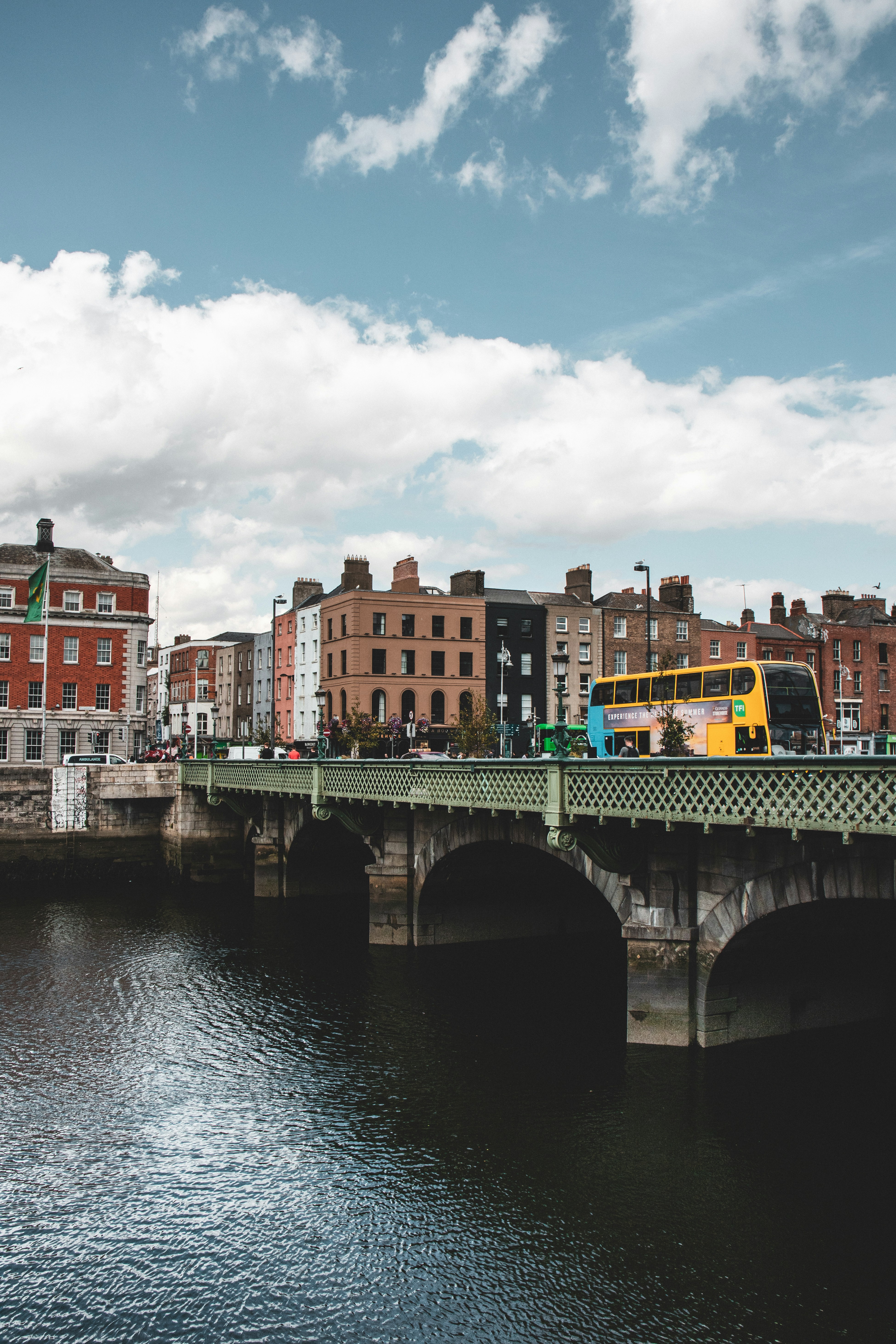 a bridge over a river with a bus on it