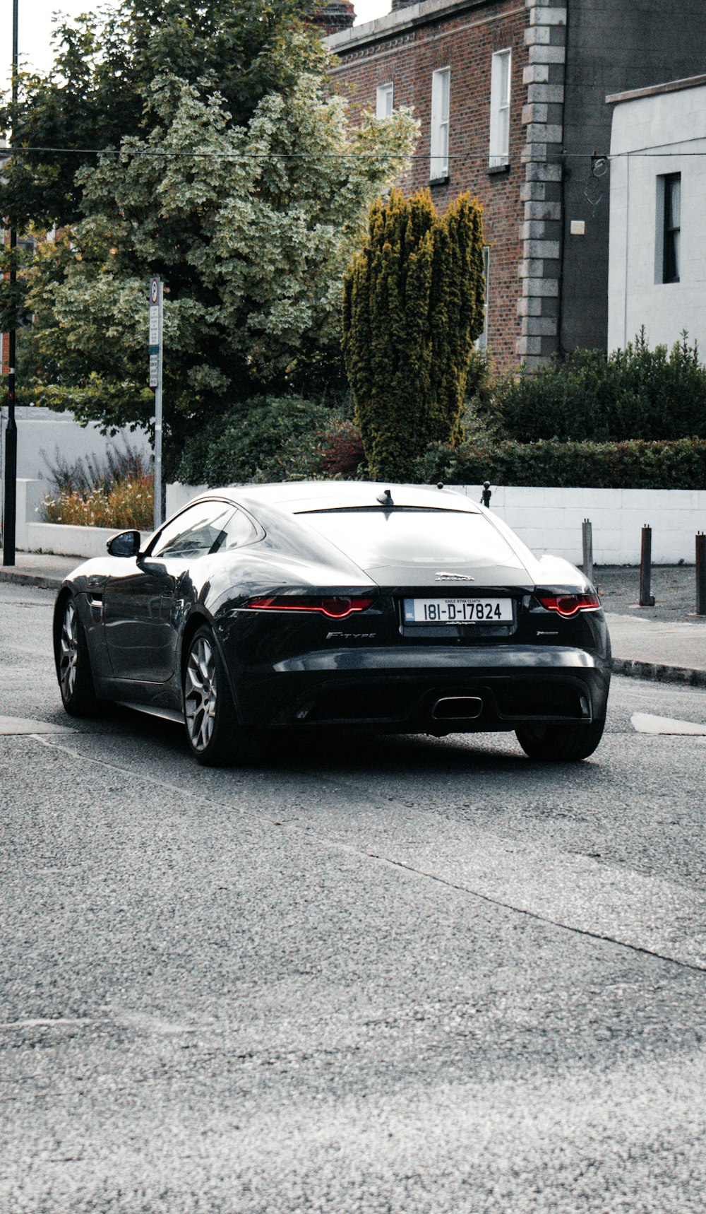 a black sports car parked on the side of a road