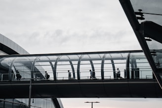 a group of people walking on a bridge