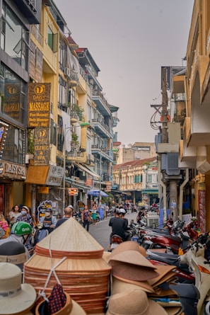 Historic Old Quarter in Hanoi bustling with motorbikes and charming colonial architecture.