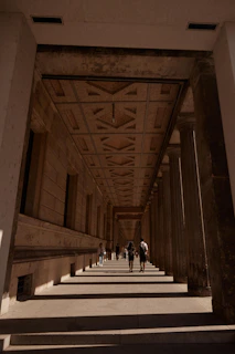 people walking down a hall way