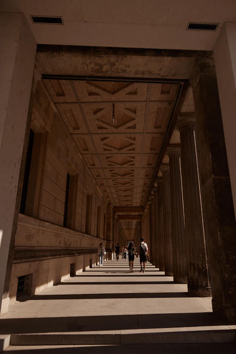 people walking down a hall way