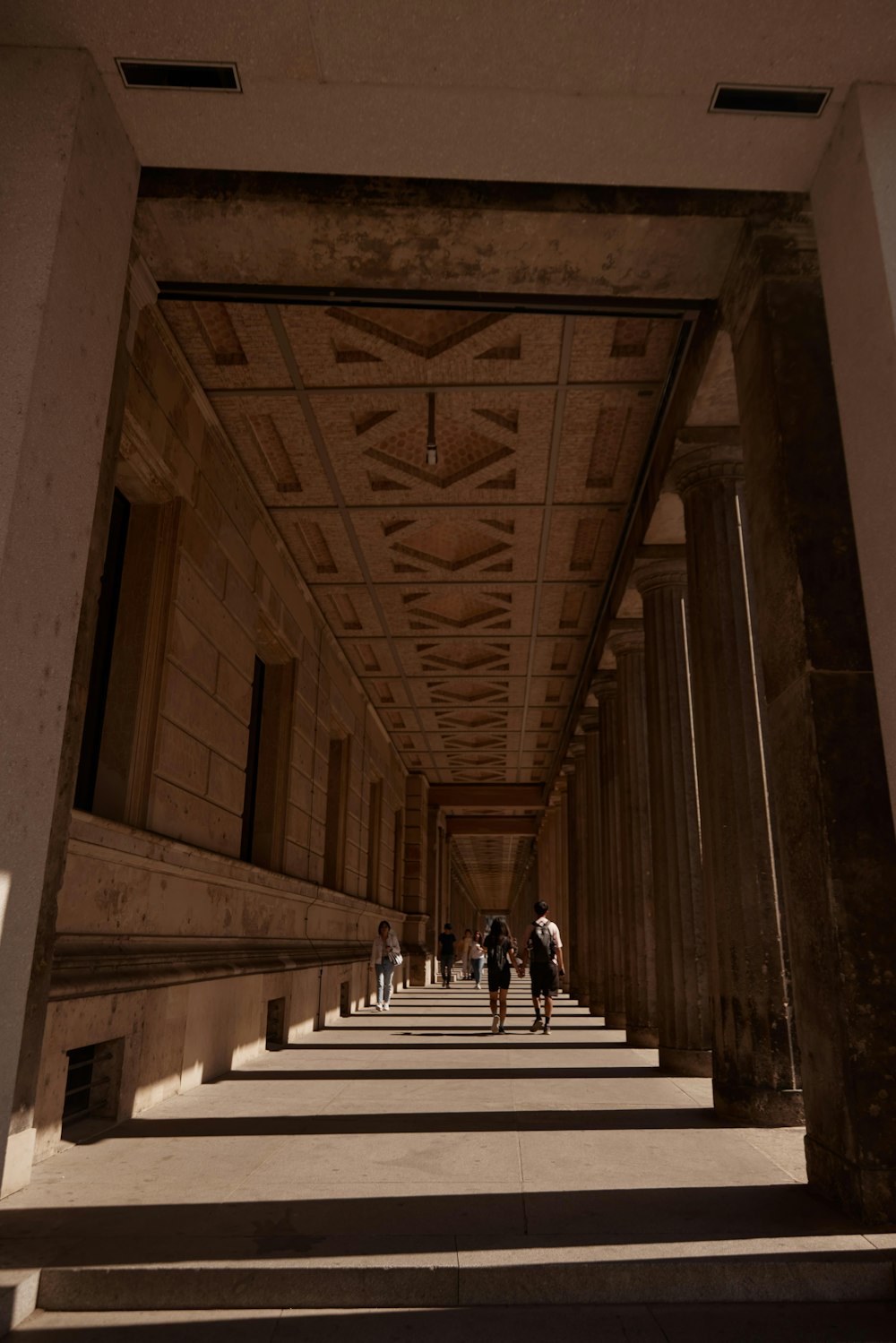 people walking down a hall way