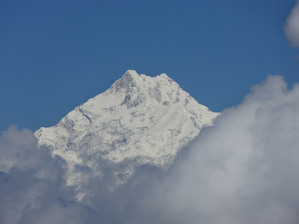 a mountain with clouds below