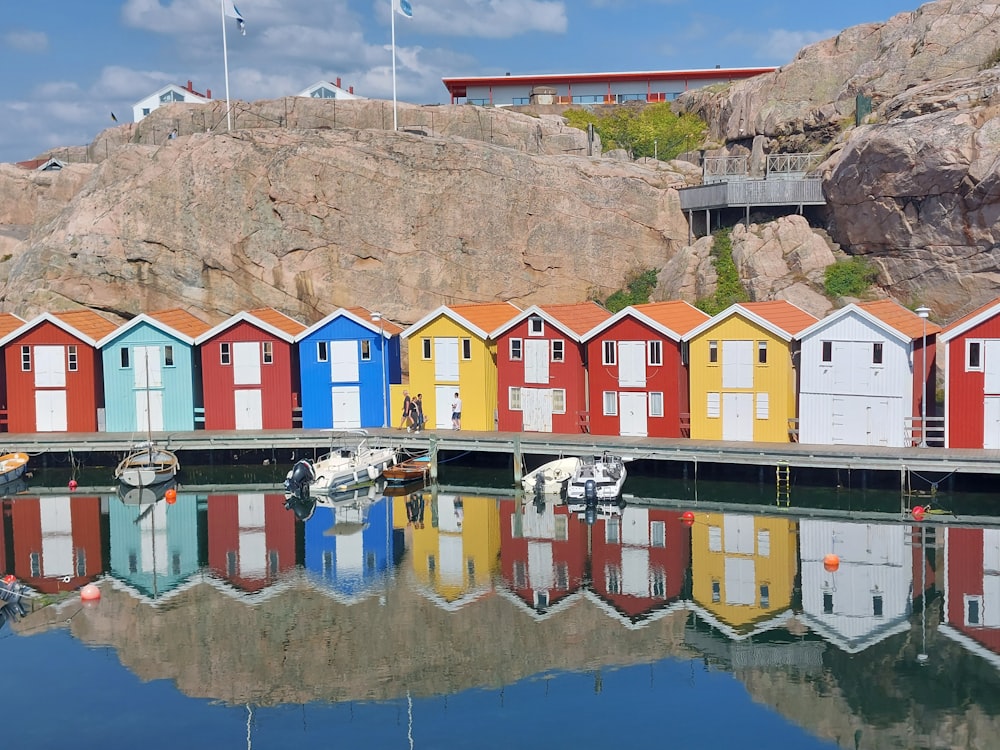 a group of colorful buildings by a body of water