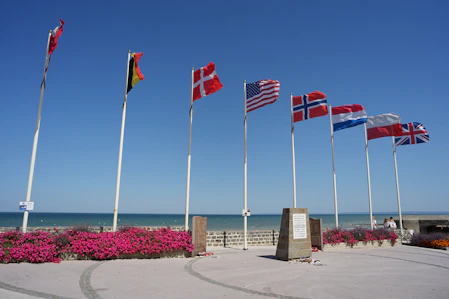 a group of flags on poles D-DAY