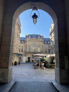 European university courtyard with historic architecture and students enjoying a coffee break.