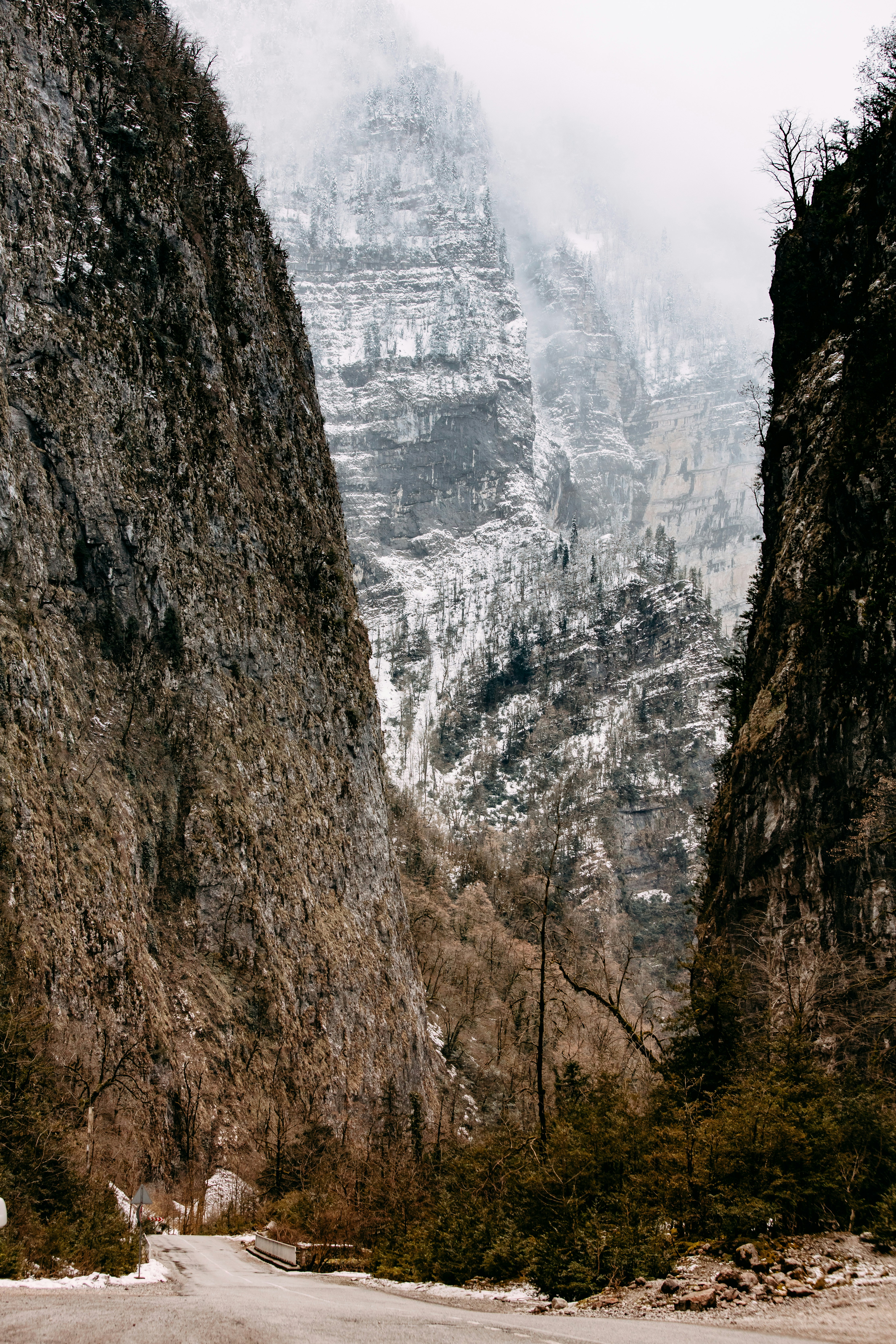a road between rocky mountains