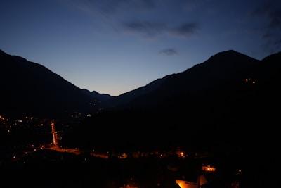 Evening view of the rest house illuminated softly against the backdrop of the hilltop sky.