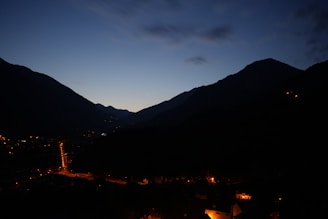 Evening view of the rest house illuminated softly against the backdrop of the hilltop sky.